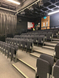 A wide and side view of theatre tip up seating