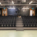 A panoramic view of rows of theatre tip-up seating