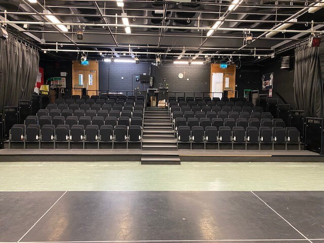 A panoramic view of rows of theatre tip-up seating
