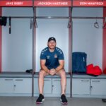 Wigan Warriors player sat on newly refurbished locker room seating